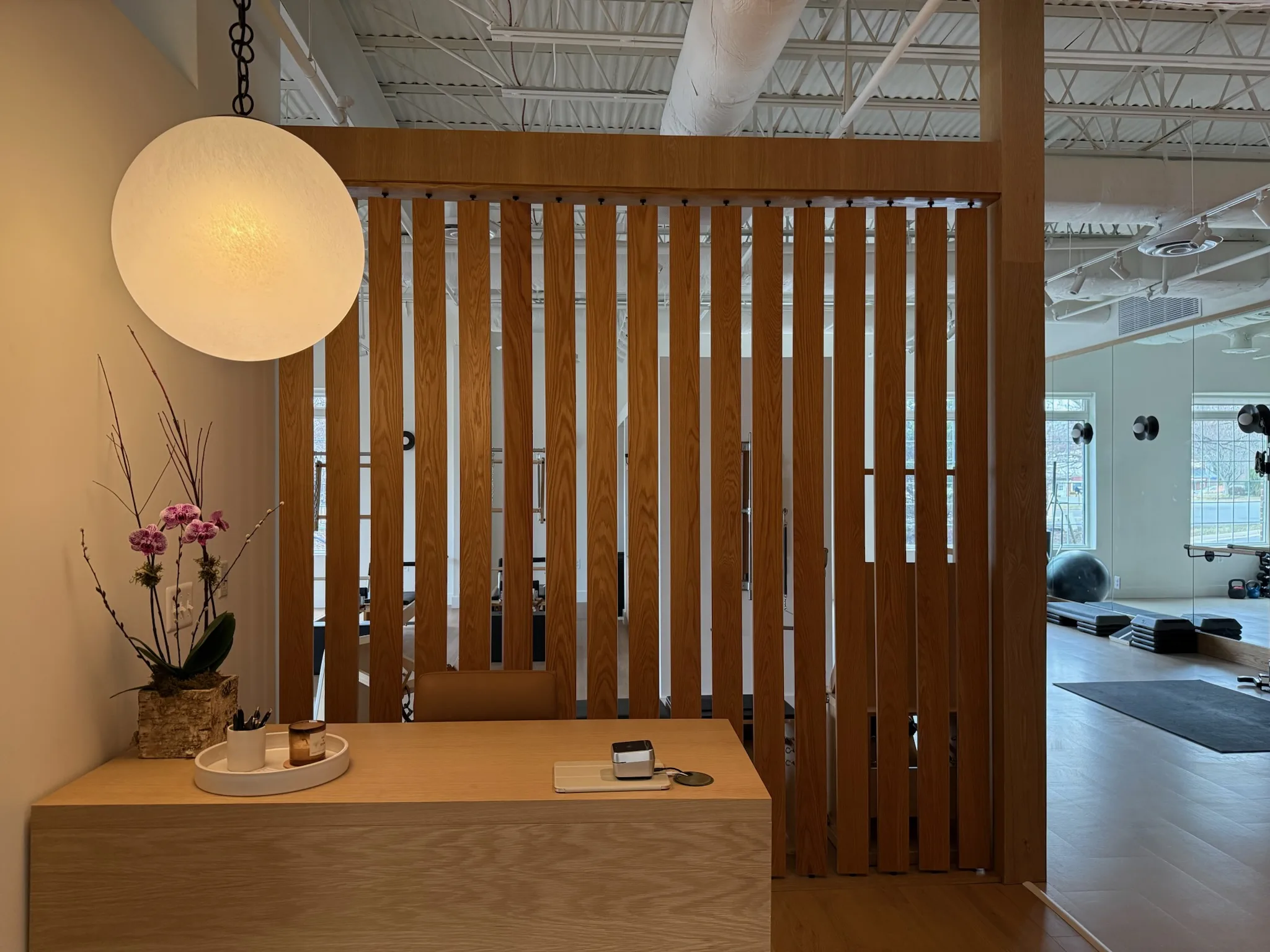 Open studio floor with strength equipment and natural light at Great Falls Movement Center