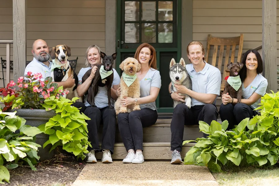 The GFPT team with their therapy dogs on the clinic porch